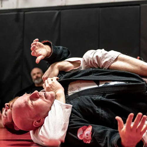 Brazilian Jiu-Jitsu practitioners demonstrating a side control escape during training.