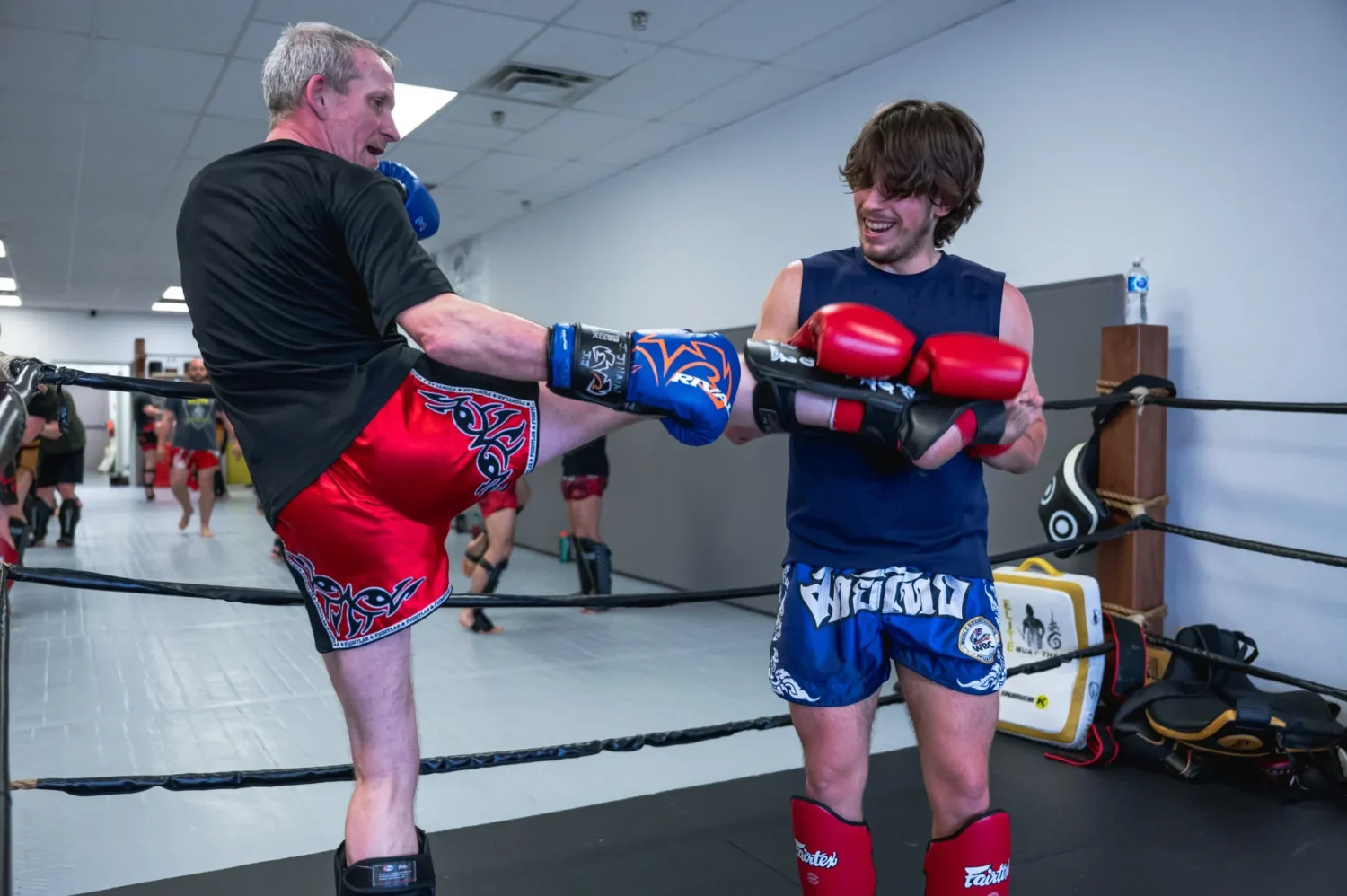 Teen martial arts Calgary practitioners exchange techniques in a training ring